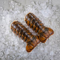 Two Boston lobster tails on a bed of crushed ice